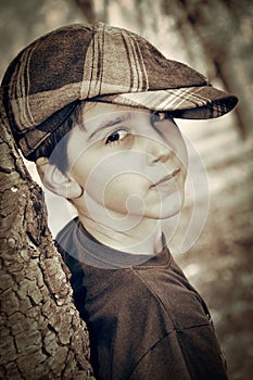 Young boy with newsboy cap playing detective