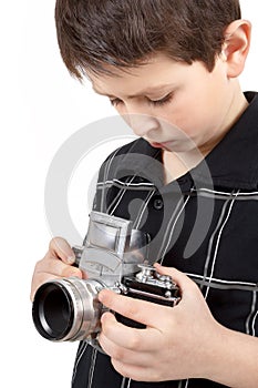 Young boy with old vintage analog SLR camera