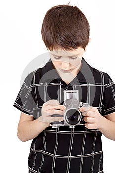 Young boy with old vintage analog SLR camera
