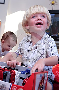 Young boy opening present at Christmas or birthday