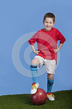 Young boy in outfit with soccer ball