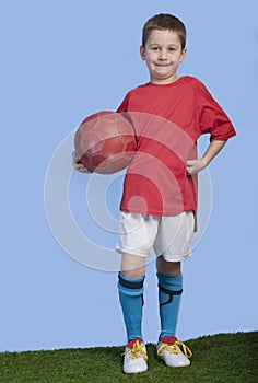 Young boy in outfit with soccer ball
