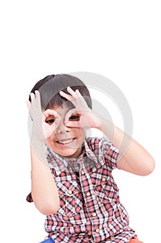 Young boy peeking through hand