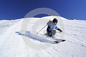 Young boy performing carved ski turn