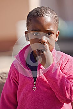 Young boy picking nose