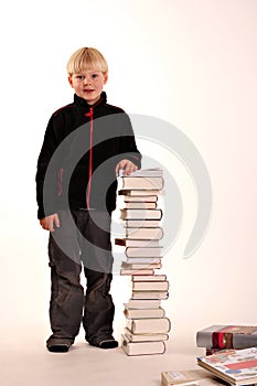 Young boy with a pile of books