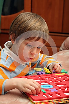 Young boy with plastic numbers.