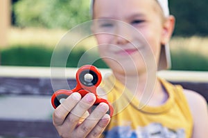Young boy play with fidget spinner stress relieving toy