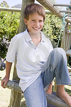 Young boy at a playground smiling