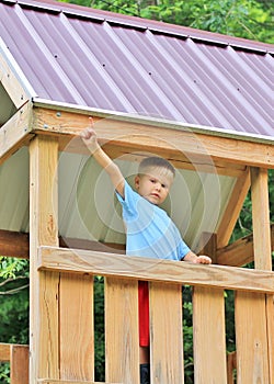 Young Boy in Playhouse Pointing Up