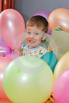 Young boy playing with balloons