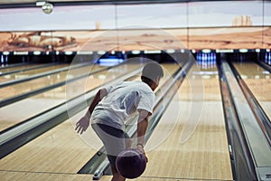 Young boy playing bowling