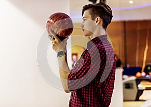 Young boy playing bowling alone