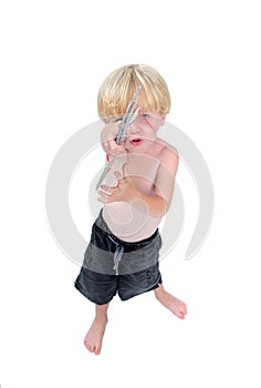 Young boy playing cardboard guitar with white background