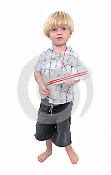 Young boy playing cardboard guitar with white background