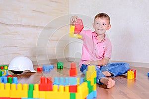 Young boy playing with colorful building blocks