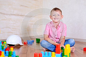 Young boy playing with colorful building blocks