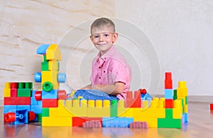 Young boy playing with colorful building blocks