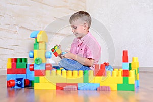 Young boy playing with colorful building blocks