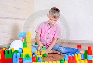 Young boy playing with colorful building blocks