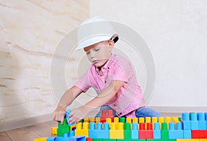 Young boy playing with colorful building blocks