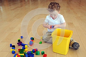 Young boy playing with coloured blocks