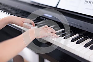 Young boy playing on a digital piano