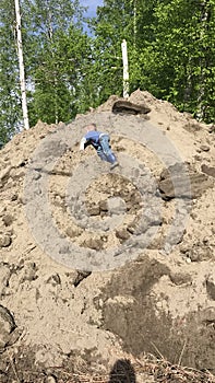 Young boy playing in the dirt outside