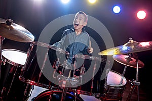 Young boy playing drums