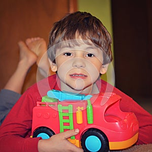 Young Boy Playing With Fire Truck