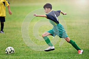 Young boy playing football