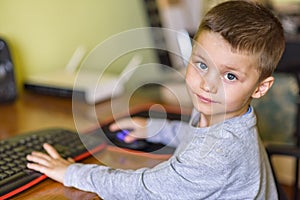 Young boy playing games on a desktop computer