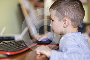 Young boy playing games on a desktop computer