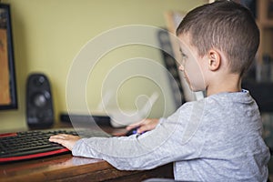 Young boy playing games on a desktop computer