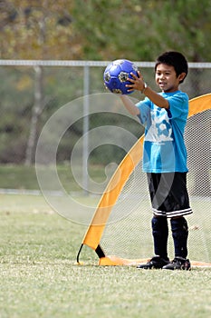 Young boy playing goalie in soccer