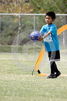 Young boy playing goalie in soccer