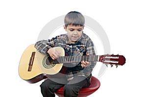 A young boy playing guitar