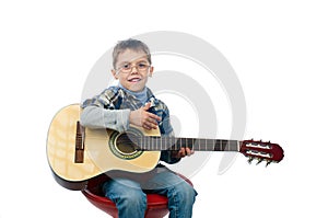 A young boy playing guitar