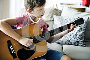 Young boy playing guitar solo