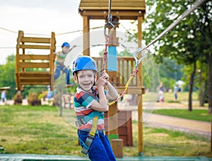 Young boy playing and having fun doing activities outdoors. Happiness and happy childhood concept