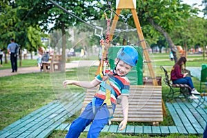 Young boy playing and having fun doing activities outdoors. Happiness and happy childhood concept