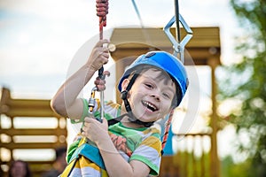 Young boy playing and having fun doing activities outdoors. Happiness and happy childhood concept