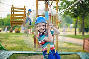 Young boy playing and having fun doing activities outdoors. Happiness and happy childhood concept