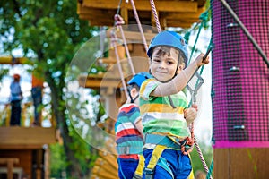 Young boy playing and having fun doing activities outdoors. Happiness and happy childhood concept