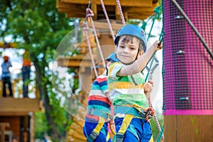 Young boy playing and having fun doing activities outdoors. Happiness and happy childhood concept