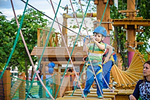 Young boy playing and having fun doing activities outdoors. Happiness and happy childhood concept