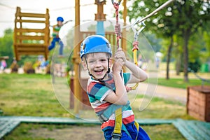 Young boy playing and having fun doing activities outdoors. Happiness and happy childhood concept