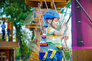 Young boy playing and having fun doing activities outdoors. Happiness and happy childhood concept