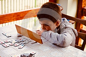 Young boy playing Rummy