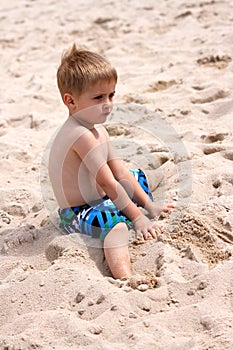 Young boy playing with sand